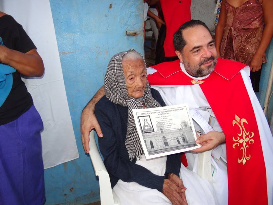 Anciana junto a al sacerdote  Eslaquit 